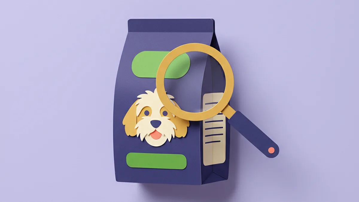 Paper-craft dog food bag with a magnifying glass held over its ingredient list, illustrating how to read a dog-food label