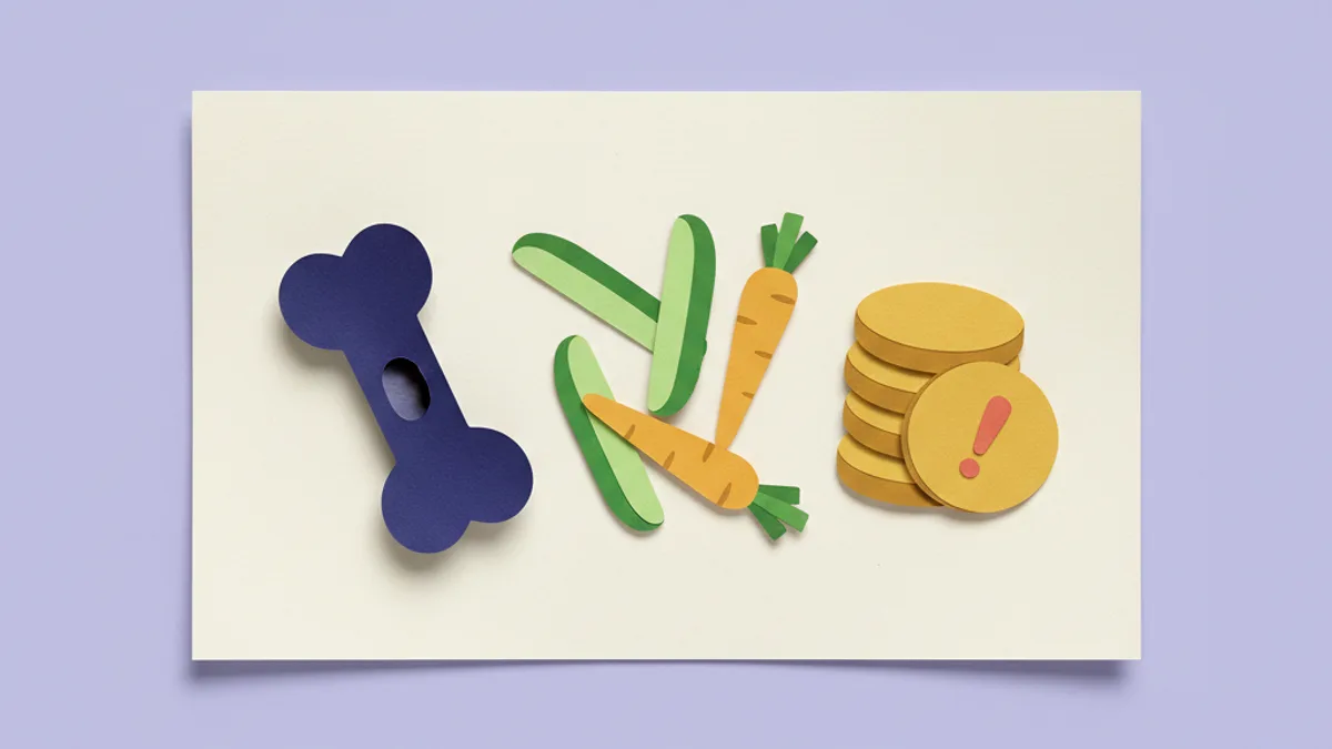 Paper-craft spread of trial-safe dog treats — a stuffed rubber toy, carrot and cucumber sticks, and baked biscuits made from the trial diet